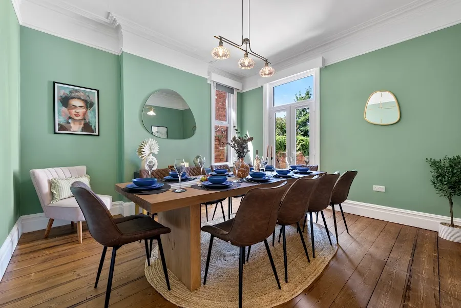 Sage-green dining room set for eight