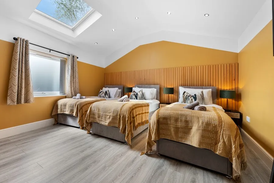 Twin bedroom with a mustard feature wall